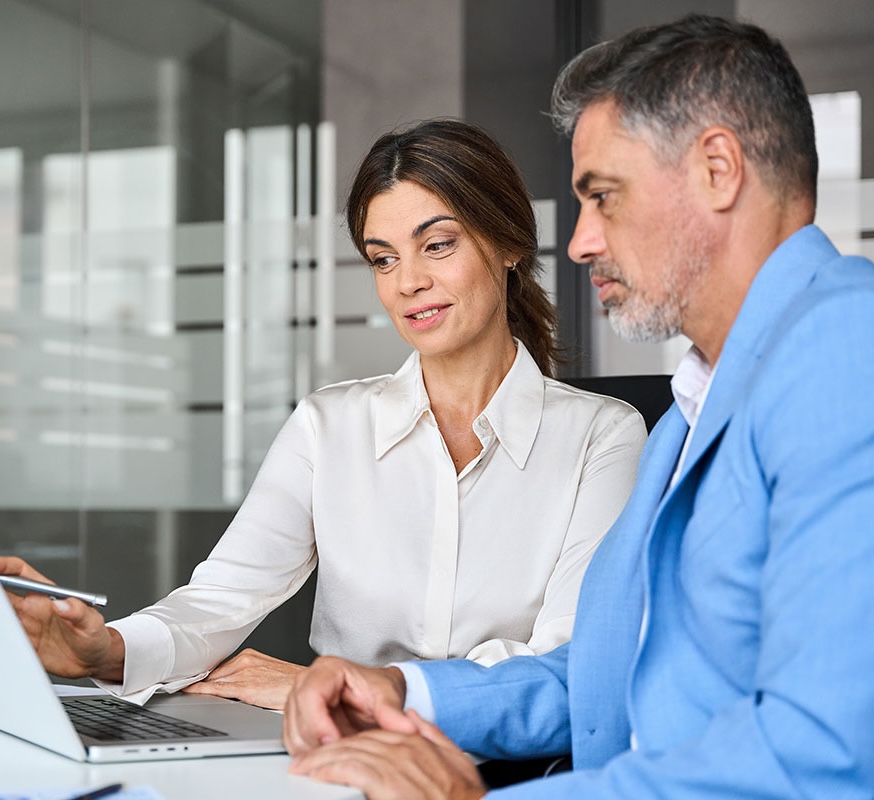 Two people looking at a laptop - Business Insurance